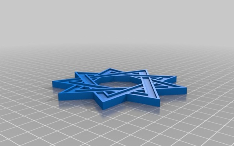 Blue plastic looking 9 pointed star against a grey background
